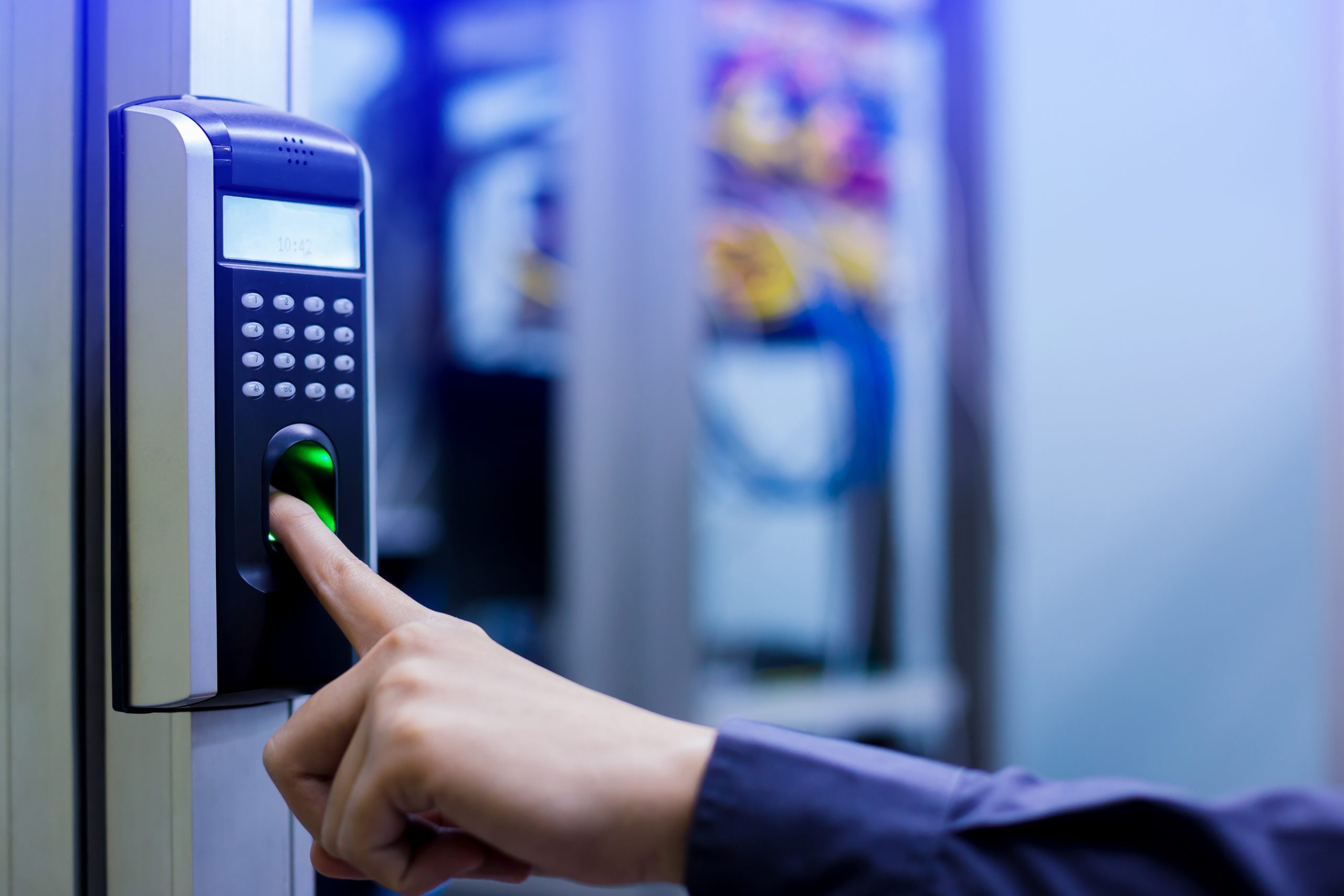 Person-scanning-fingerprint-on-biometric-access-control-system-scaled